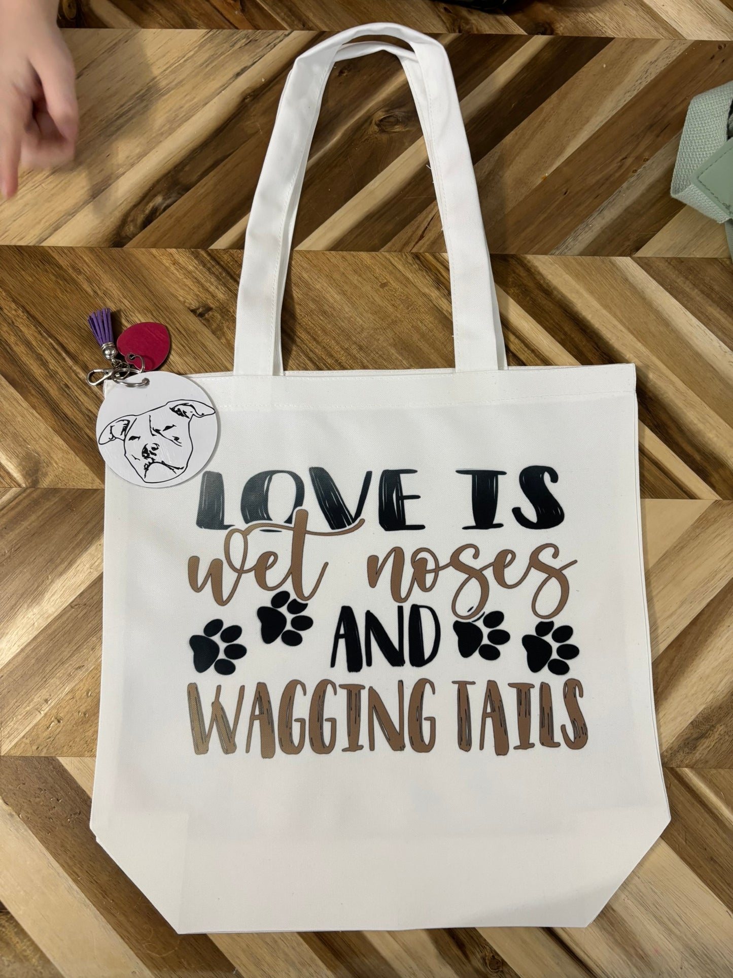 Love is wet noses and wagging tails tote bag
