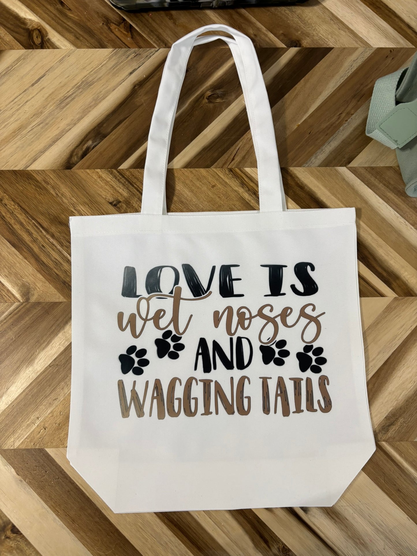 Love is wet noses and wagging tails tote bag